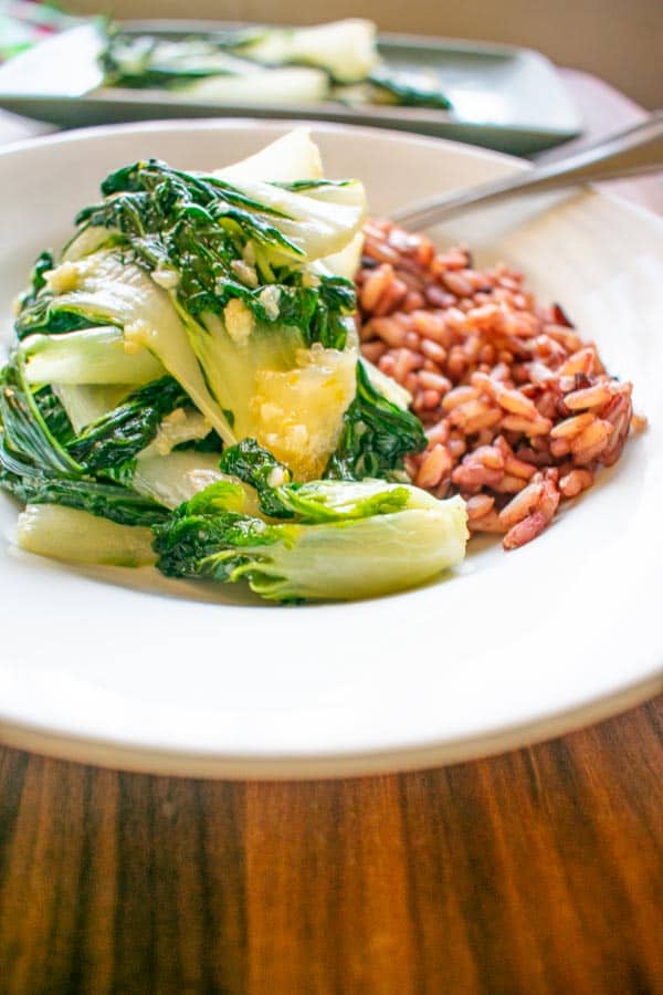 baby bok choy stir fry with red rice on plate