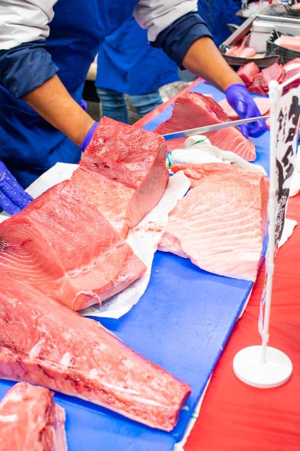 cutting fresh ahi tuna on blue cutting boards