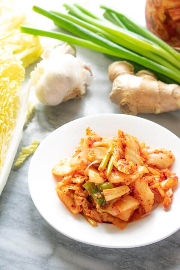 kimchi on white plate with vegetables