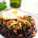thai basil chicken with fried egg and purple rice