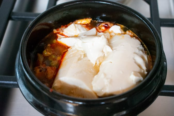 Silken Tofu in black pot for Vegan Korean Soft Tofu Soup for Soondubu