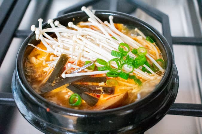 Vegan Korean Soft Tofu Soup or Soondubu Jigae in black pot