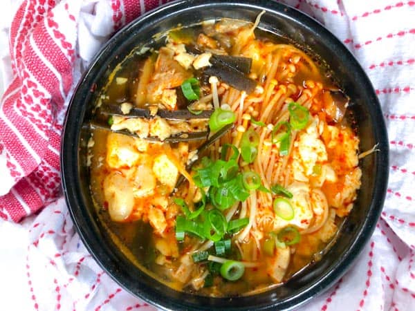 Vegan Korean Soft Tofu Soup or Soondubu Jigae in black pot