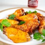 3 ingredient sriracha chicken wings on white plate