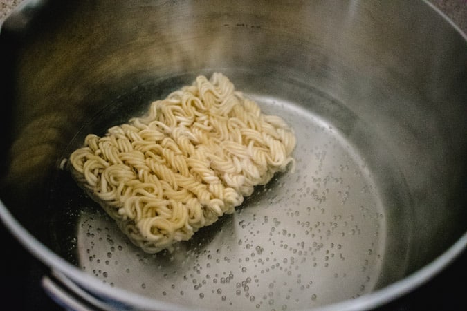 Dried ramen noodles in pot of boiling water