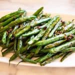 Blackened blue lake green beans on a white plate