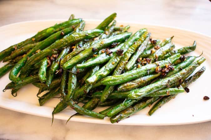 Blackened blue lake green beans on a white plate