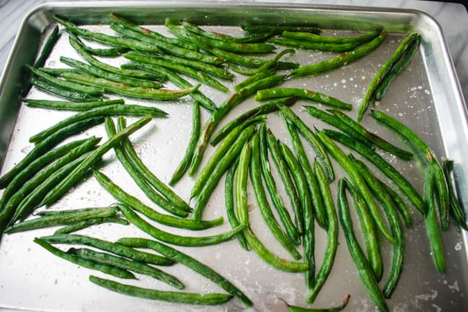 roasted green beans on baking sheet