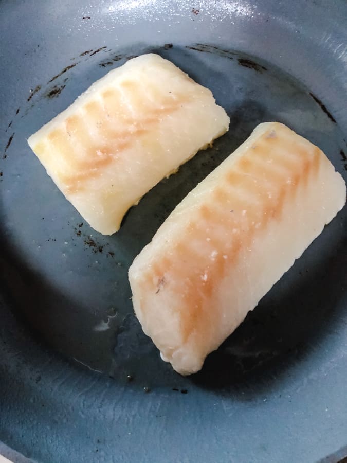 2 fillets of skinless cod in a non stick pan