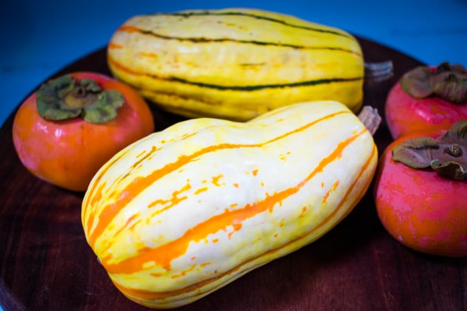 Two Delicata squash and 3 persimmons