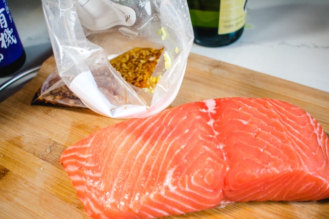 Salmon fillet and open ziploc bag with Japanese marinade