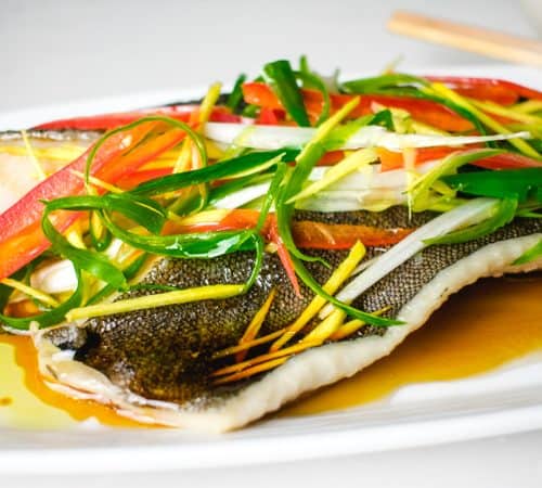 chinese steamed fish on a white platter