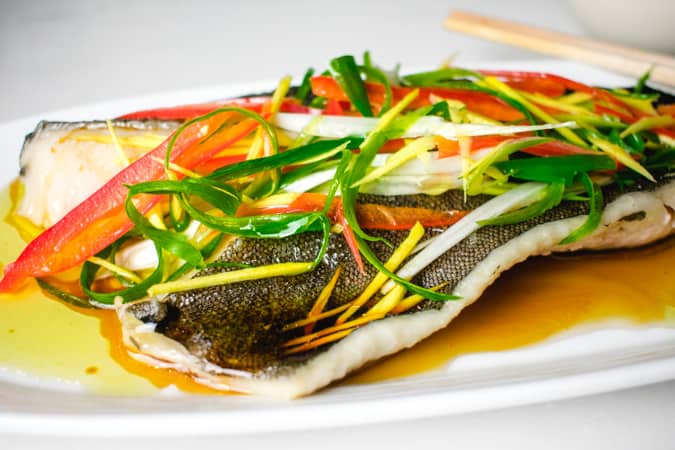 chinese steamed fish on a white platter