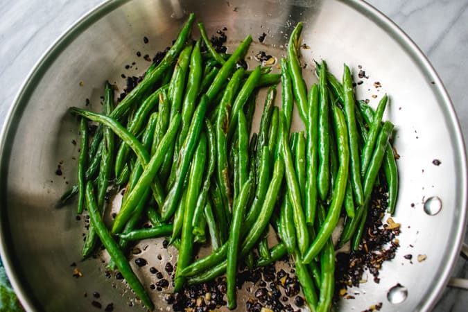 roasted green beans in skillet with Chinese fermented black beans