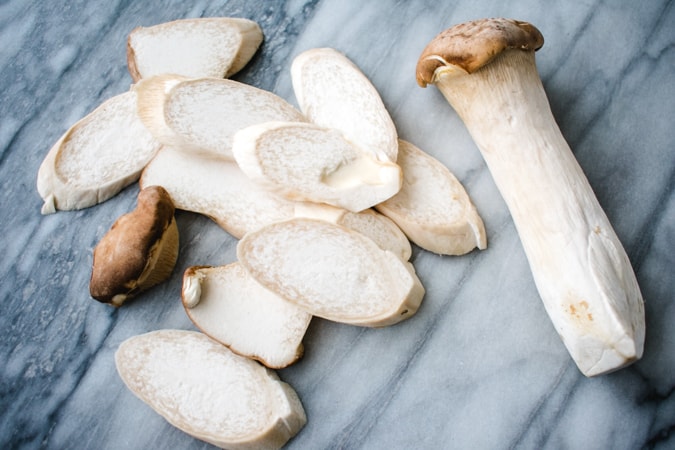 king oyster mushrooms on a marble board