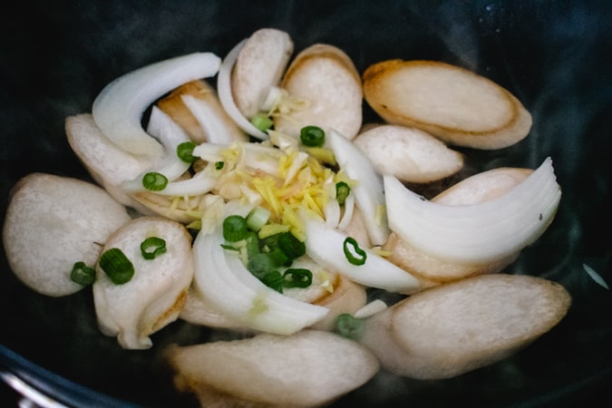 mushroom, onion, ginger, garlic, and green onion in a wok