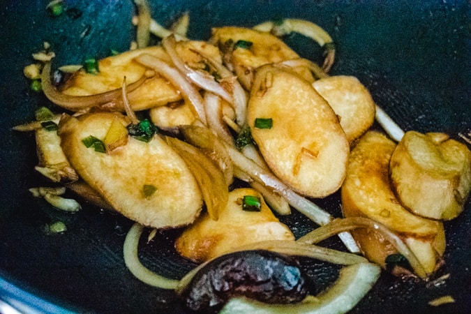 mushrooms and onion in the wok