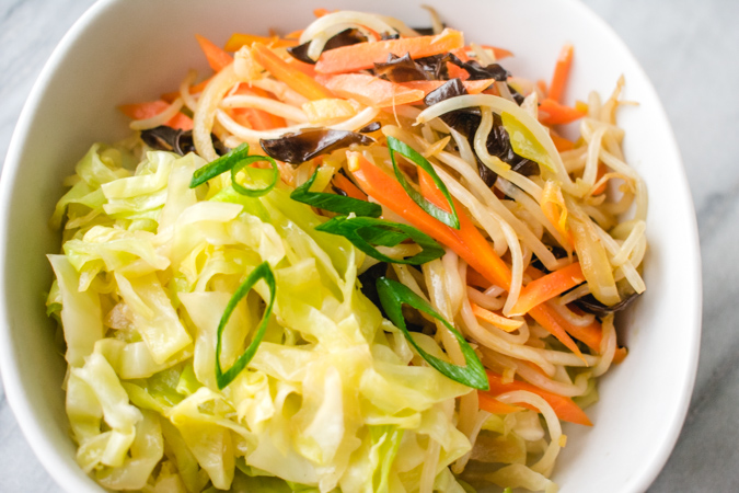 stir fried cabbage and mixed vegetables in a bowl