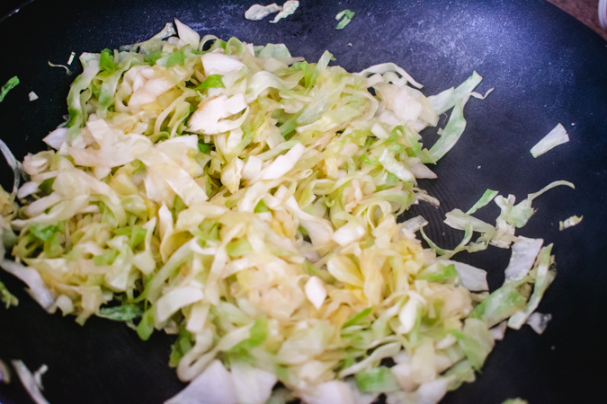 cabbage stir fried in a wok