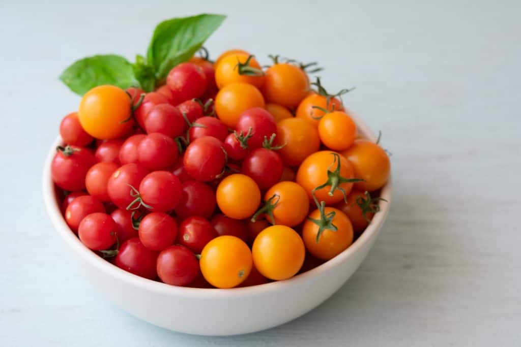 yellow and red cherry tomatoes in a bowl