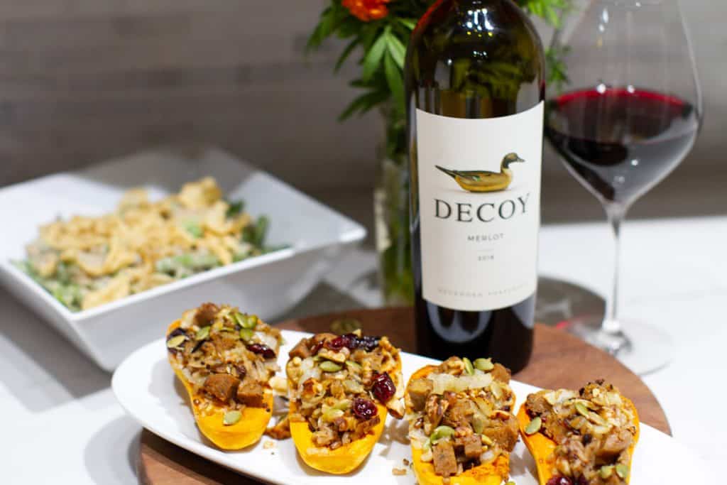 Decoy merlot wine with stuffed honeynut squash and green bean casserole in the background