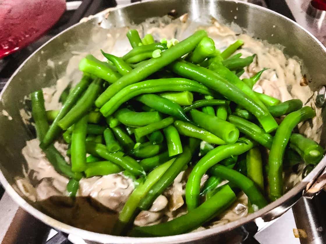 cooked green beans on top of coconut mushrooms soup