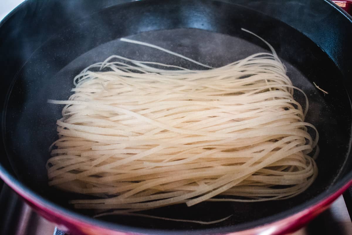 rice noodles soaking in a pot