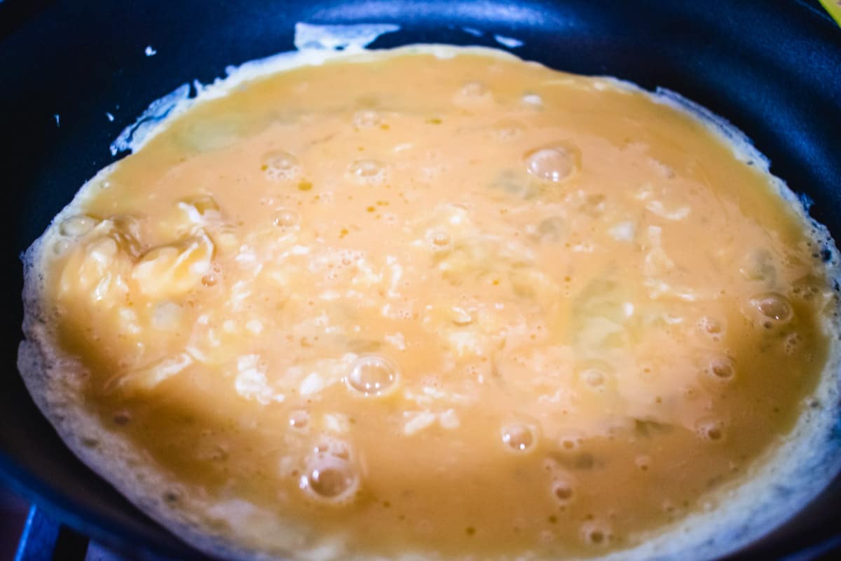 egg cooking in a nonstick pan