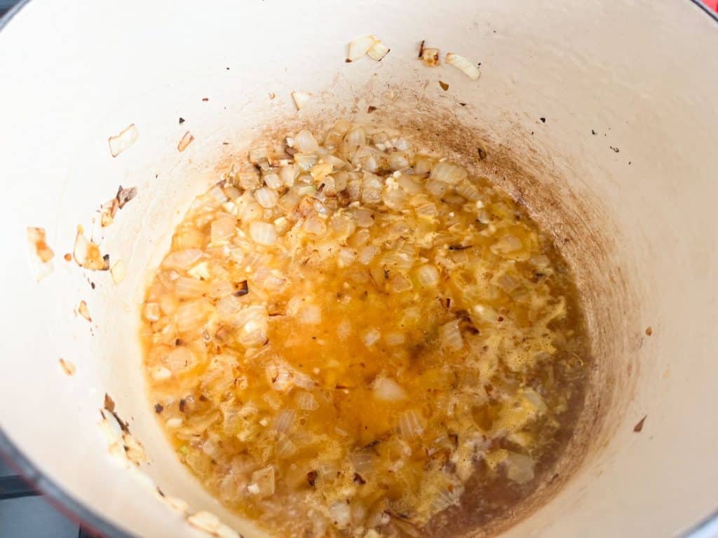browned onions and vegetable stock in a dutch oven