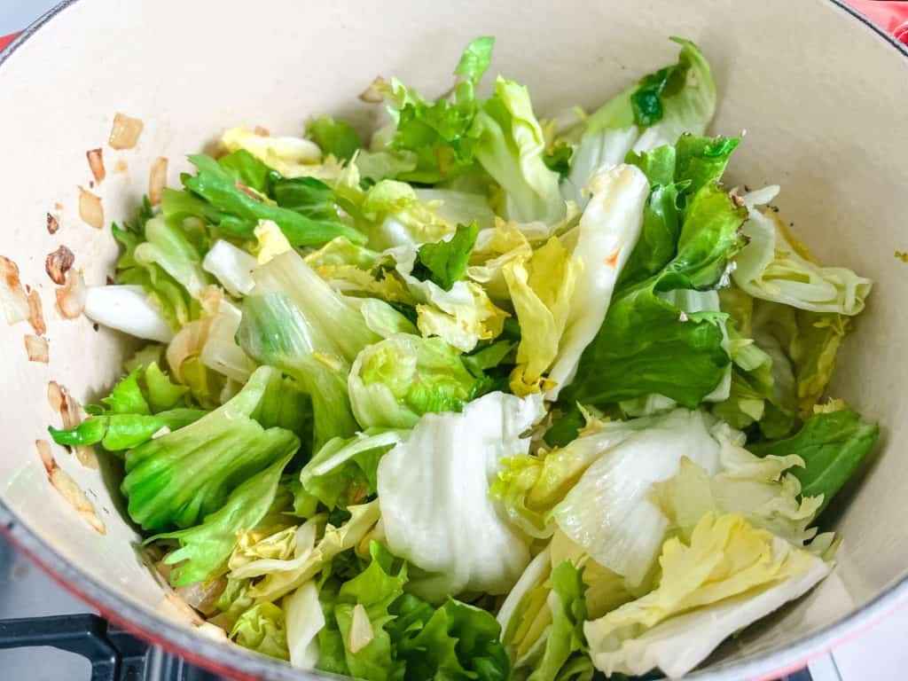 uncooked escarole in a dutch oven