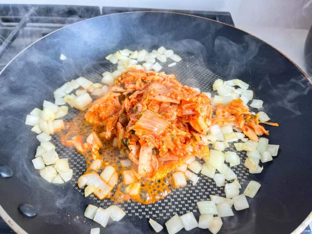 kimchi and diced onion in a nonstick skillet