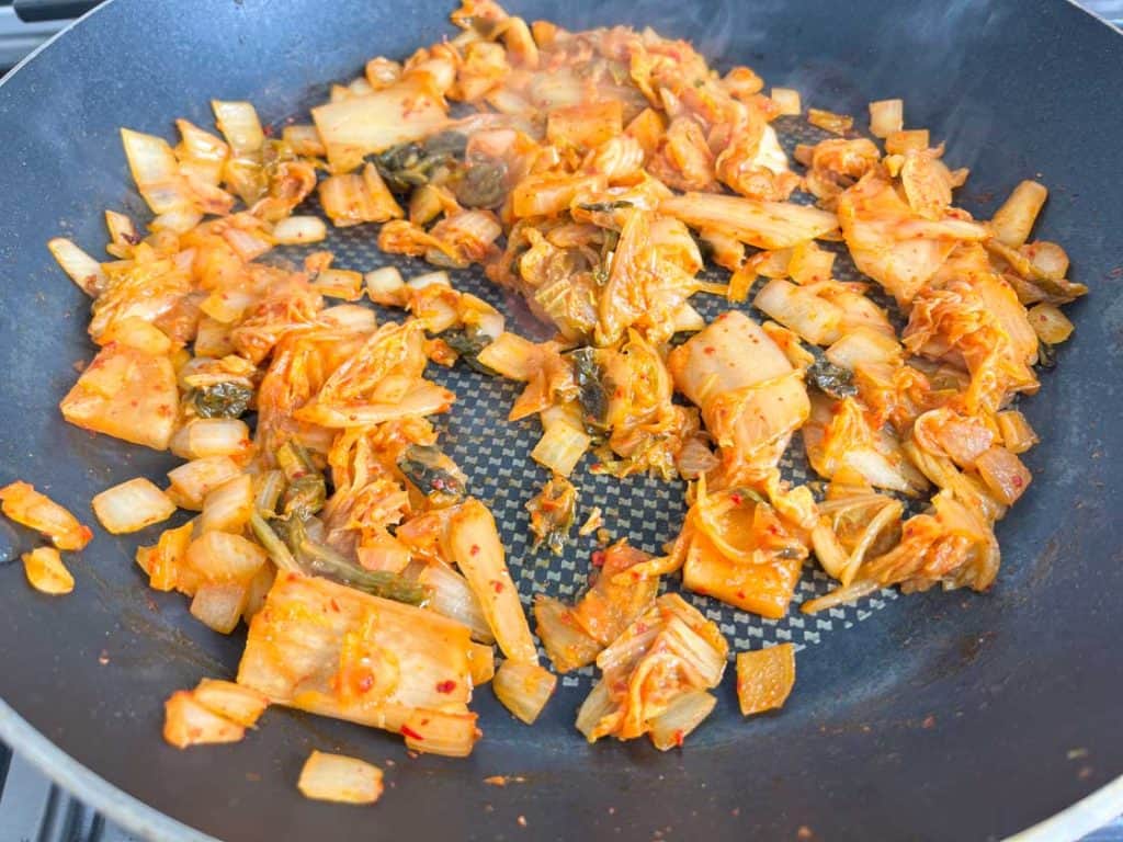 sauteed kimchi and onion in a nonstick skillet