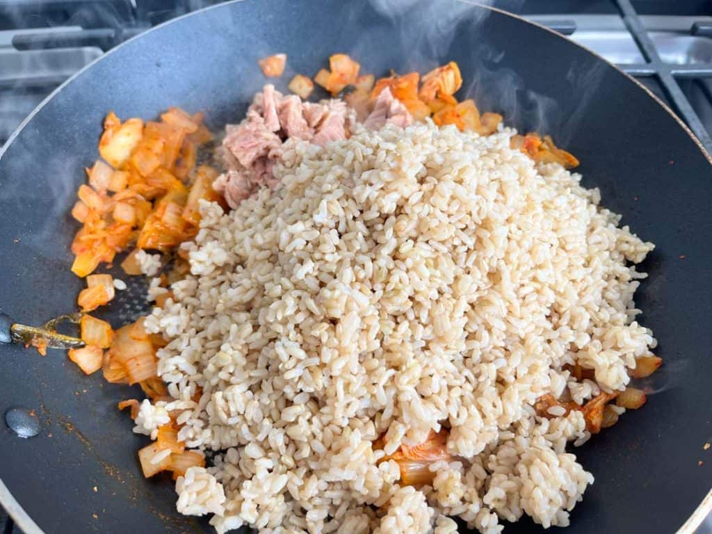 brown rice in a skillet with tuna and kimchi