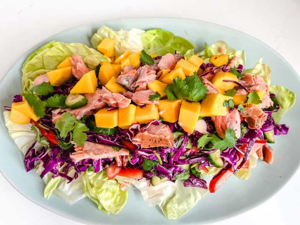 Thai Mango Salad on a blue oval plate