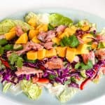 Thai Mango Salad on a blue oval plate