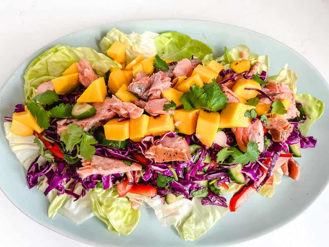 Thai Mango Salad on a blue oval plate