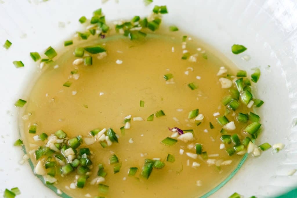 mango salmon salad dressing in a glass bowl