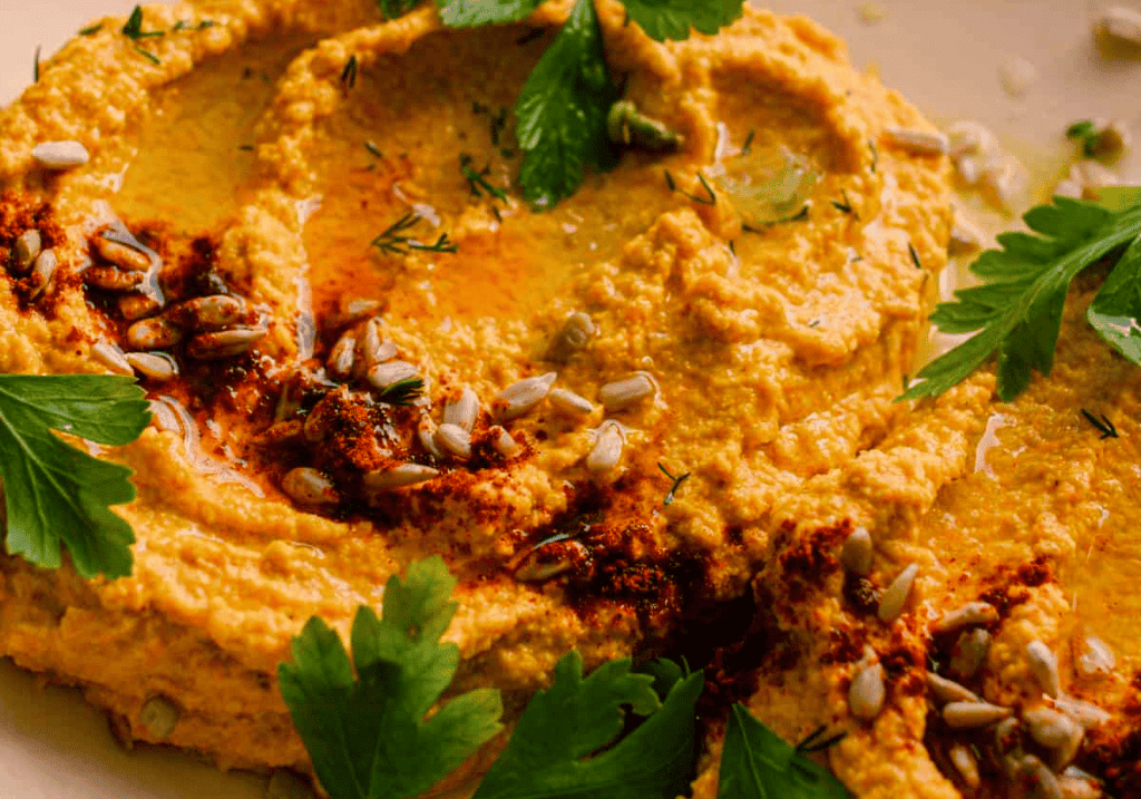 close up shot of chili lime sunflower dip with parsley leaf garnish