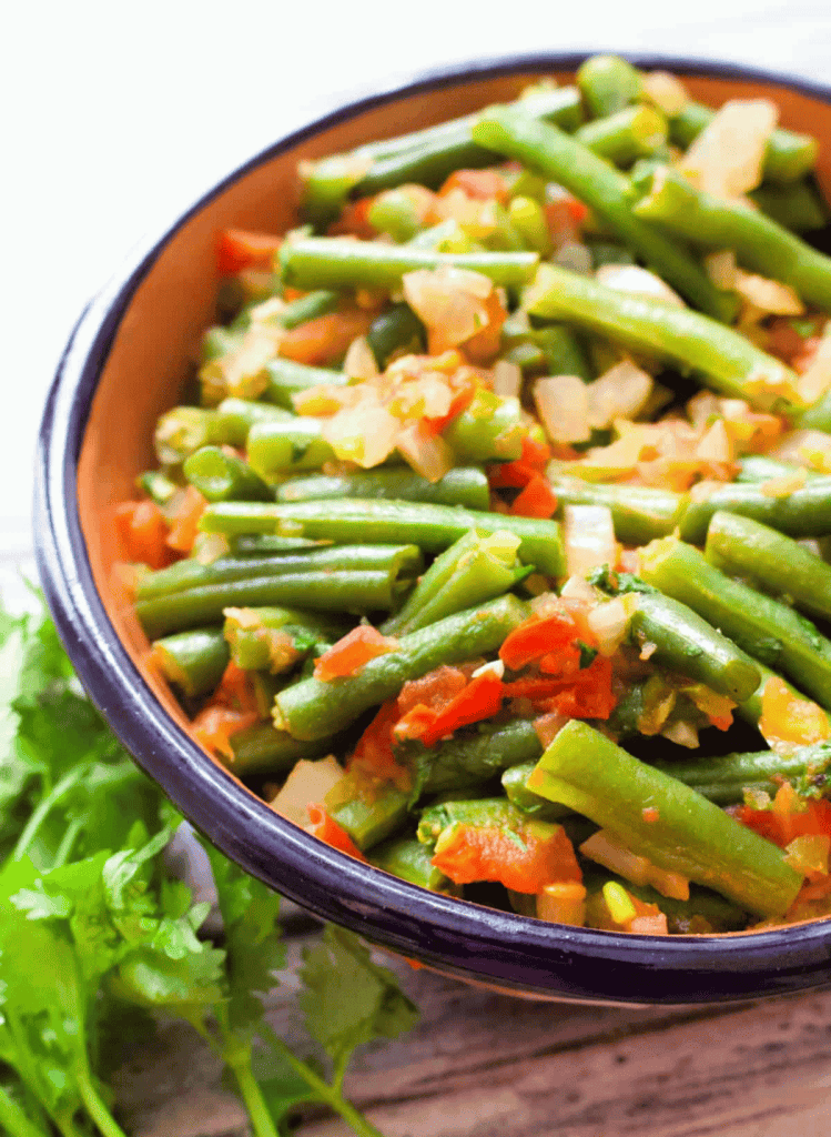 Mexican green beans in a blue rimmed bowl