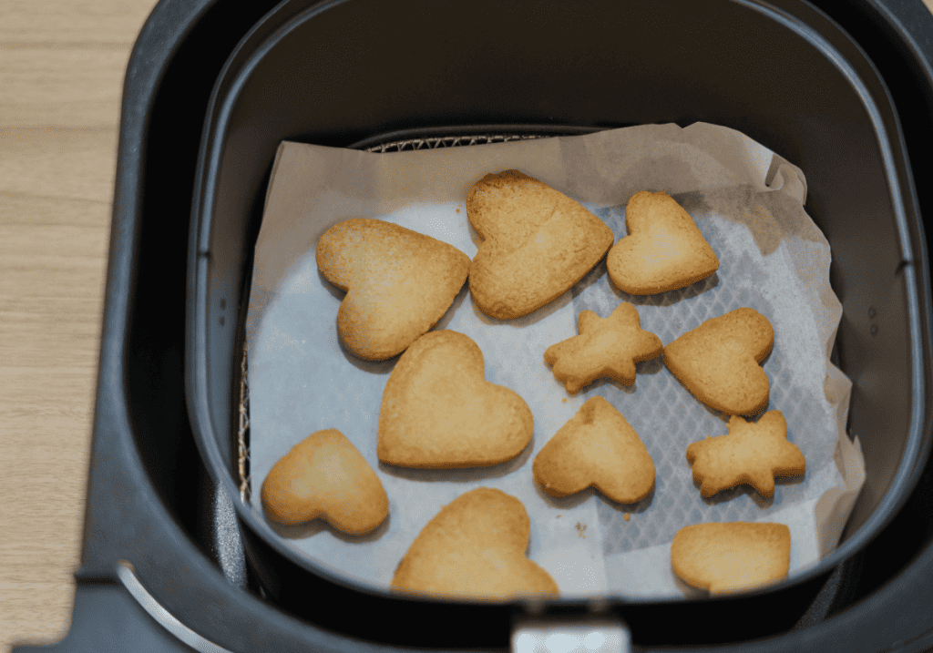 heart shaped cookies in parchment paper in an air fryer