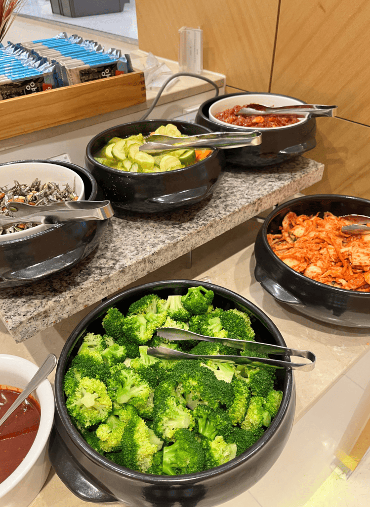 Korean broccoli in the wild. At the Hotel Hyundai breakfast buffet in Yeongam-gun, Korea, steamed broccoli is served with a side of gochujang hot sauce along with kimchi, dried stir fried anchovies, cucumber pickles, and pickled chili squid. 