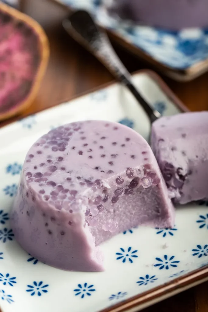 Purple sweet potato tapioca pudding on a white plate with a blue design.