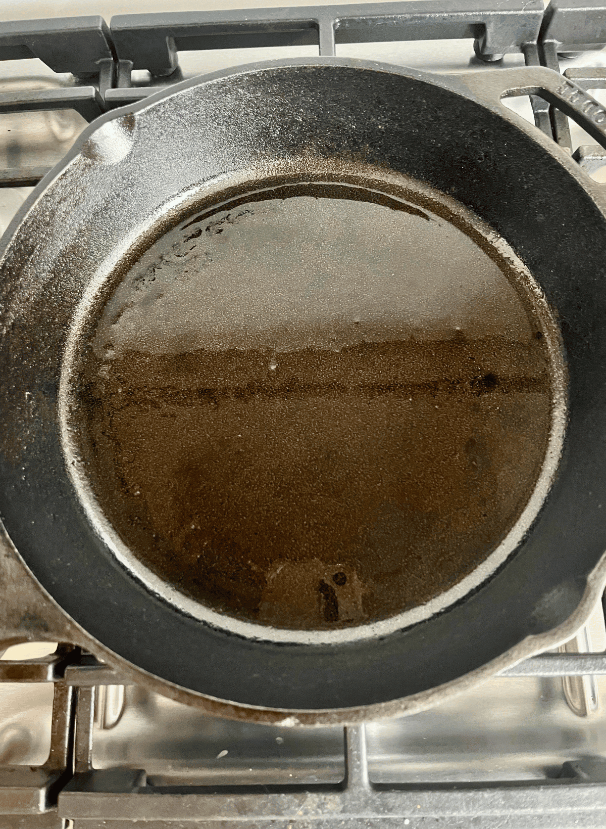 oil in a cast iron skillet on a gas range