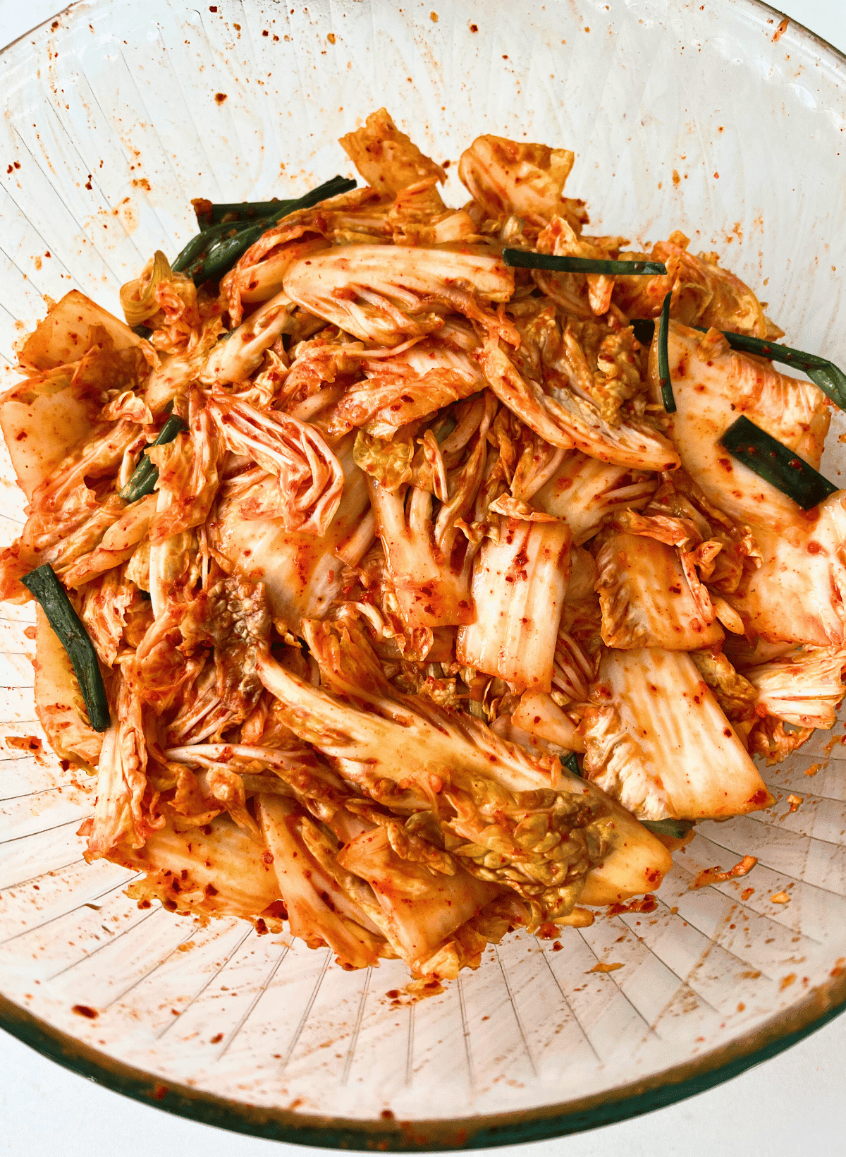 Fresh napa cabbage kimchi in a glass bowl