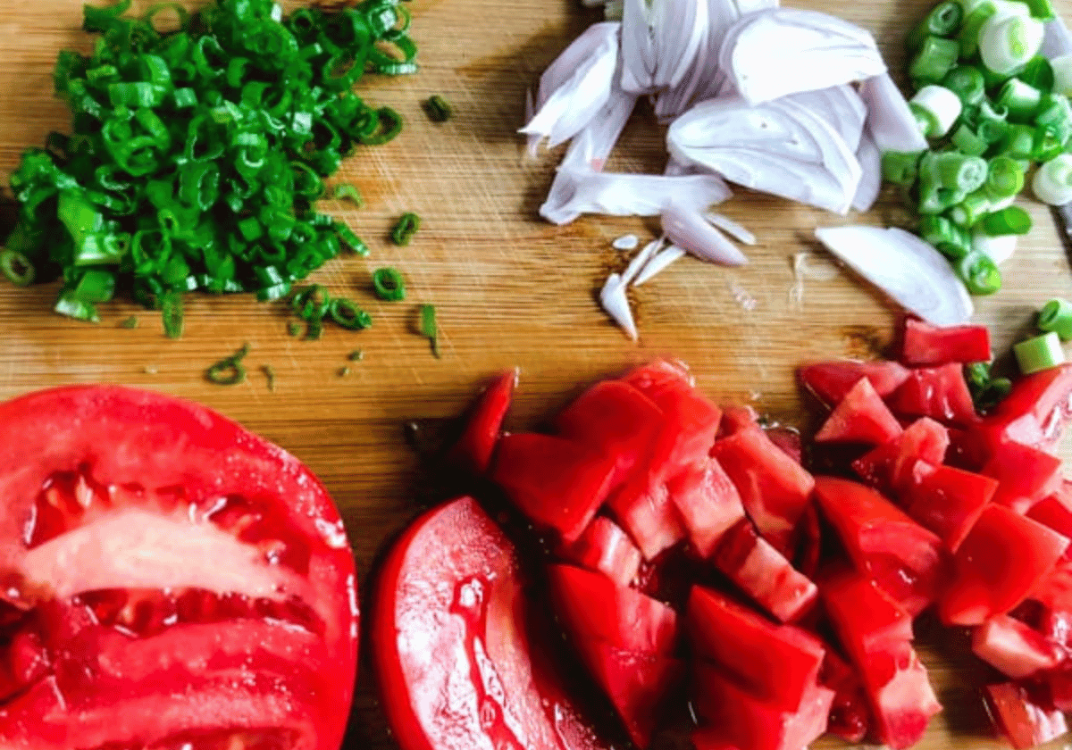 chopped vegetable ingredients on a wooden cutting board for Vietnamese fried fish