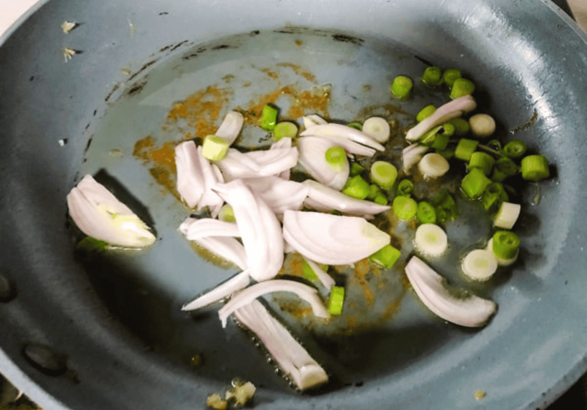 shallots and green onion in a silver pan