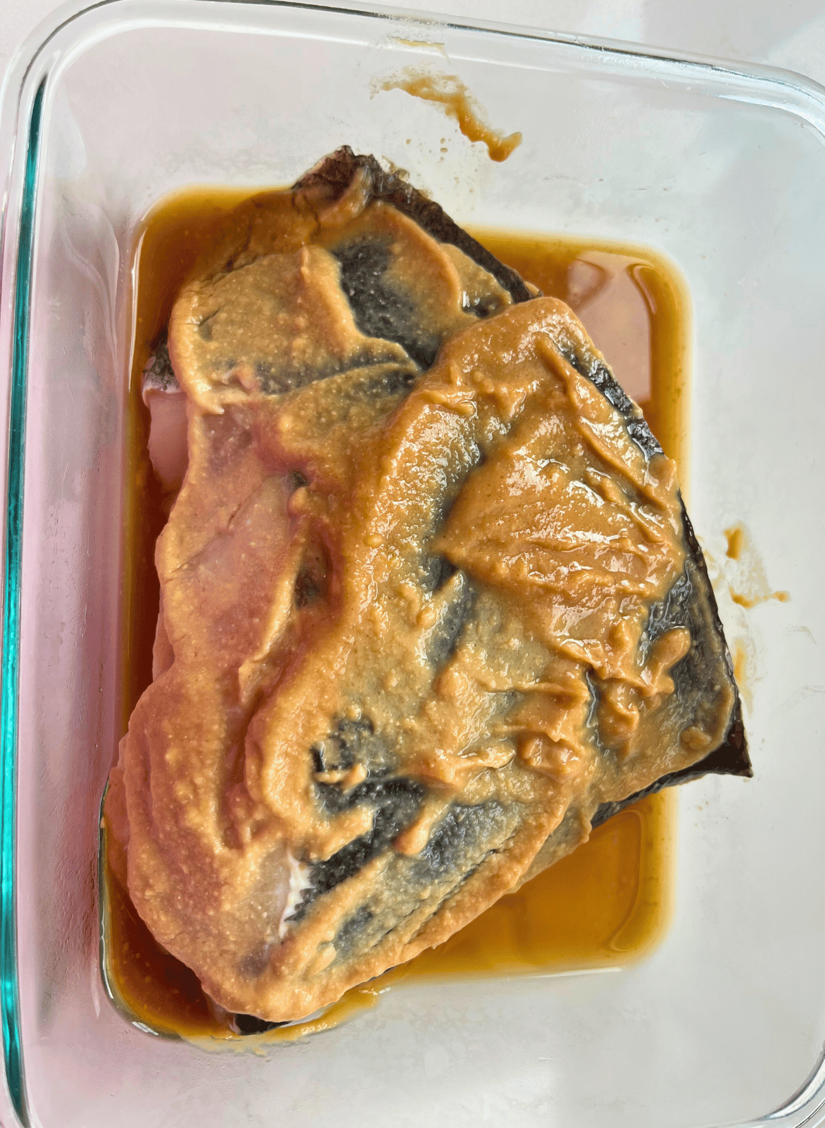 Nobu's chilean sea bass marinated in a glass container