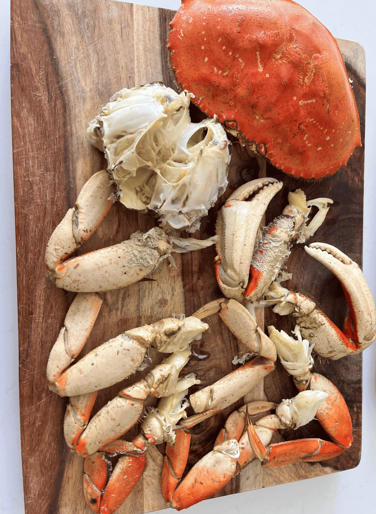 Dungeness Crab pieces on a wooden cutting board