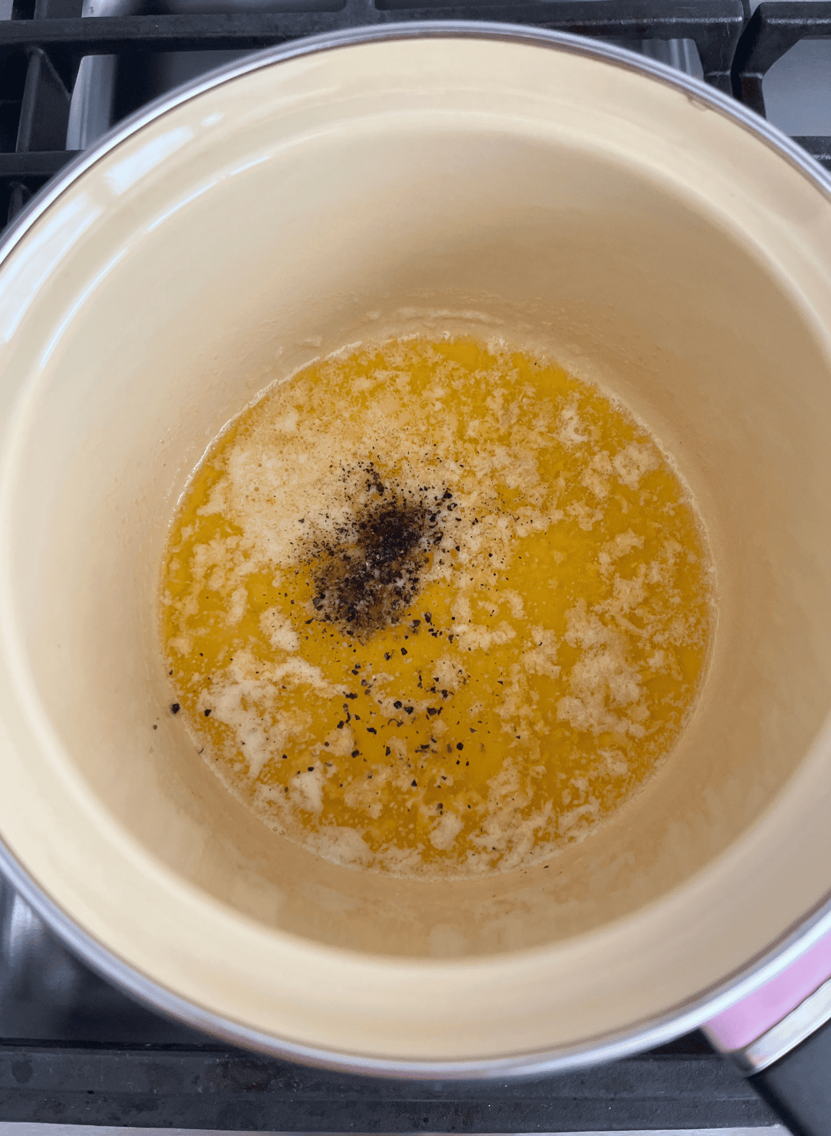 Garlic butter sauce in a pan with black pepper