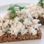 rockfish salad on whole wheat bread and dill sprig garnish